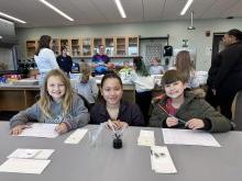 Elementary students in a lab during a field trip to Utica University.